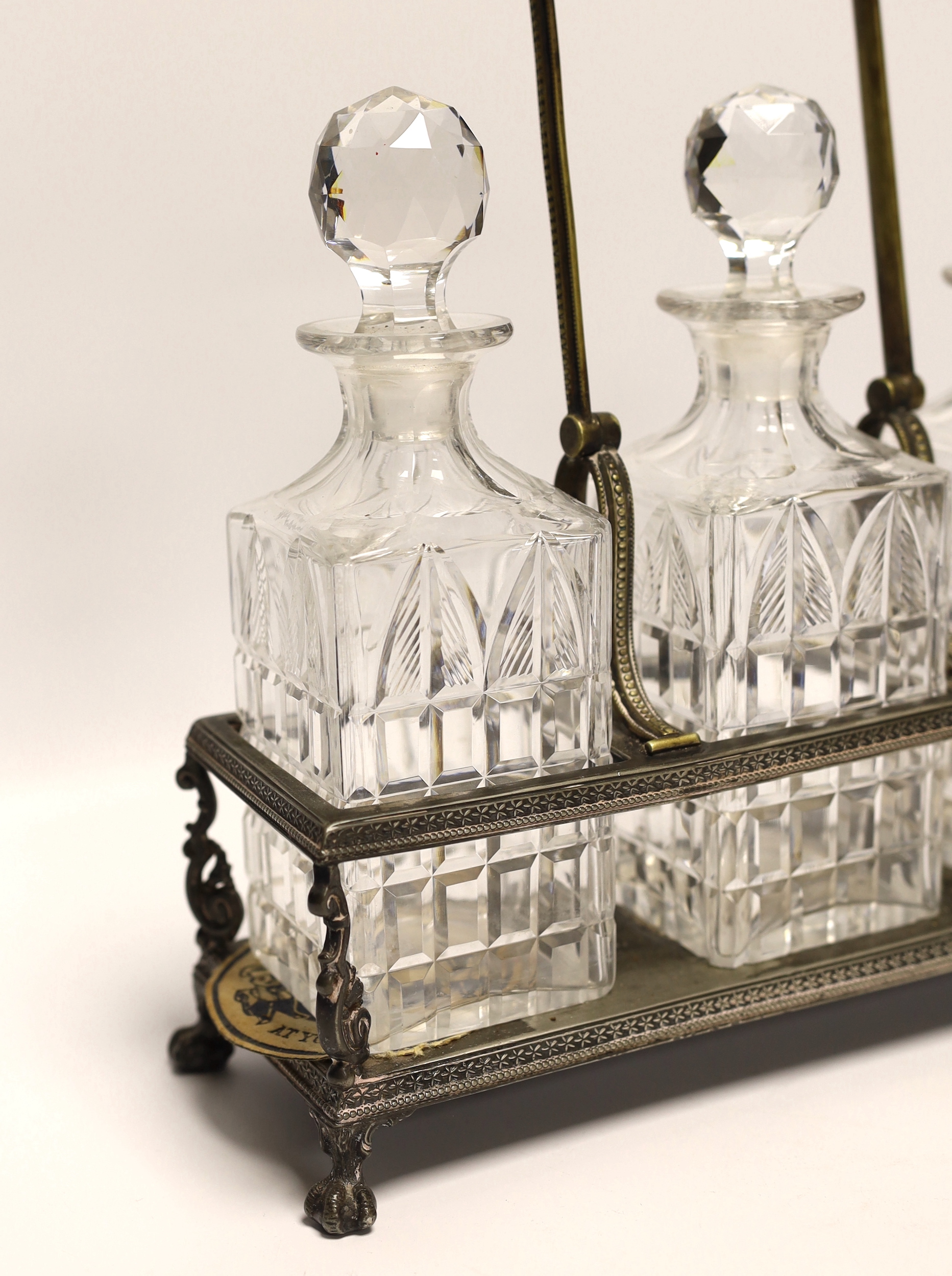 A silver plated three decanter tantalus